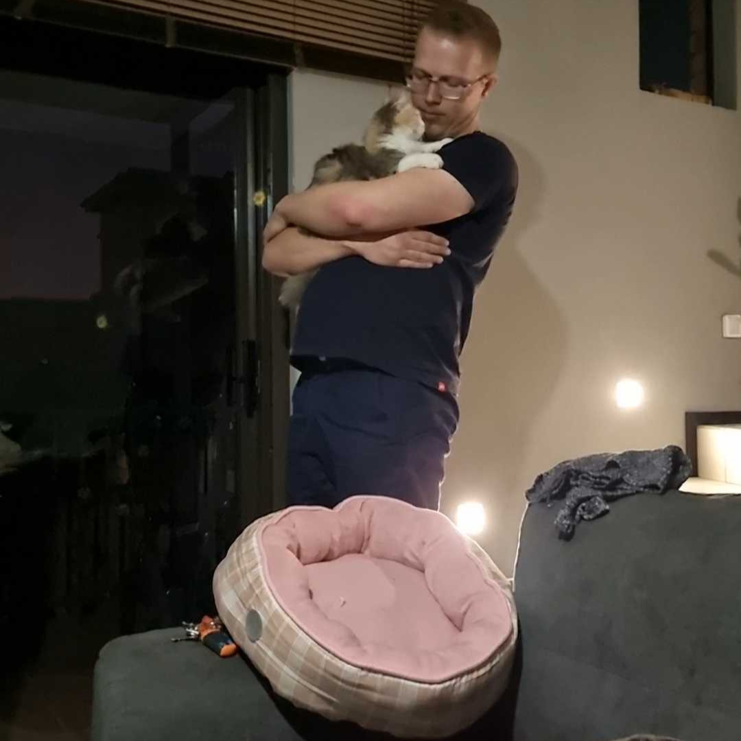Working her magic on my fiance + her cute cat bed